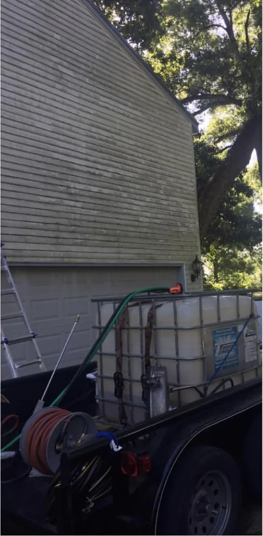 The same vinyl siding streaked green with mildew before house washing